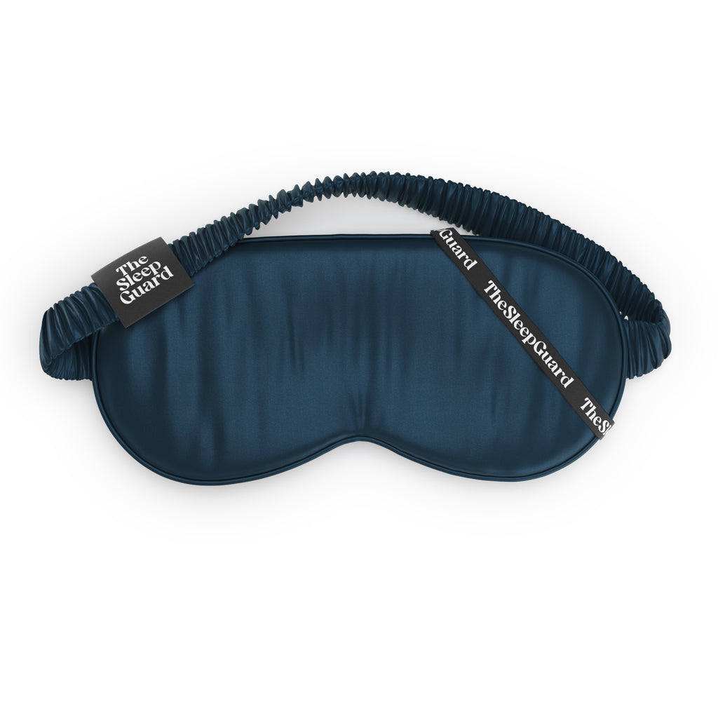 Blue sleep mask with brown strap on a white background