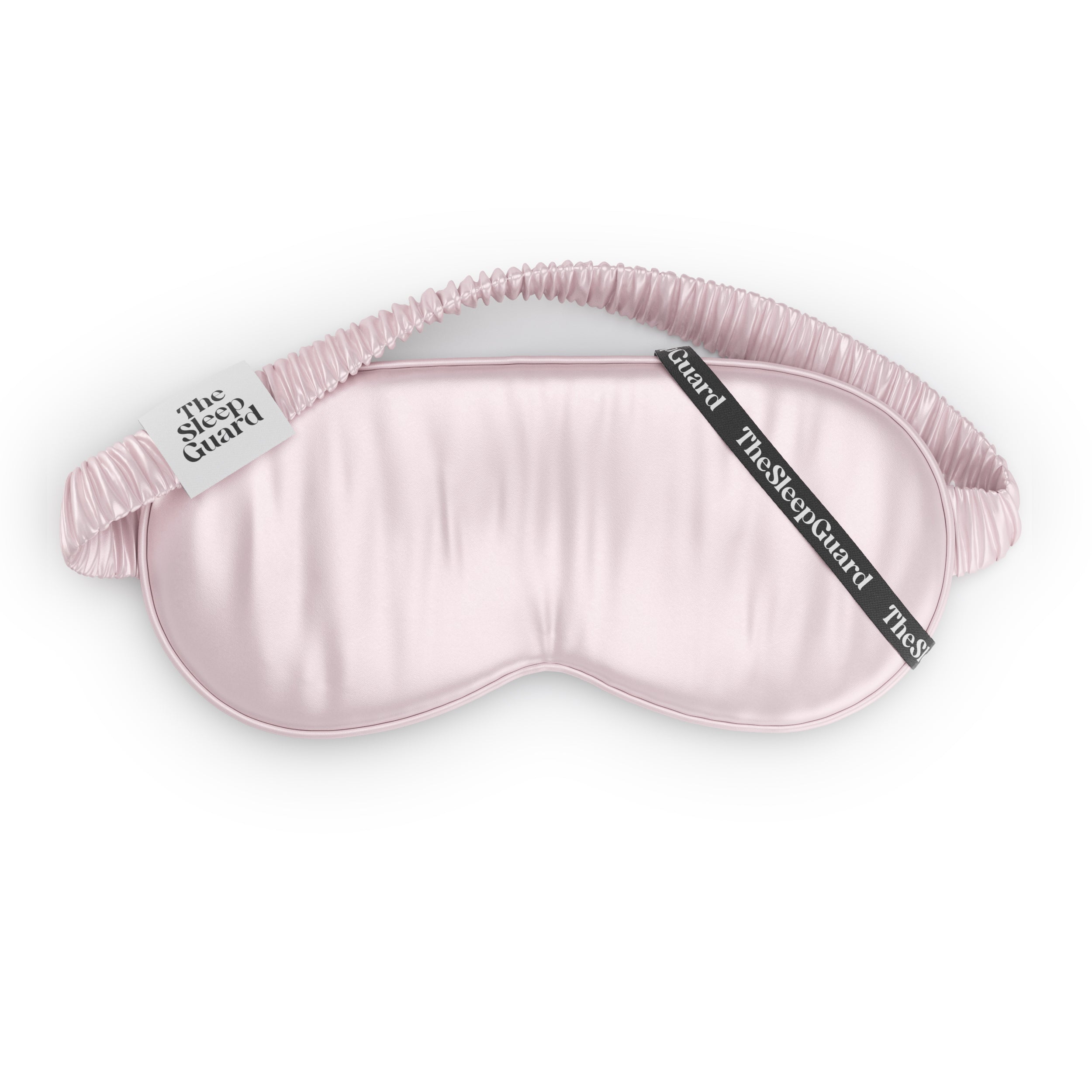 Pink satin silk sleep mask with 'The Sleep Guard' branding on a white background